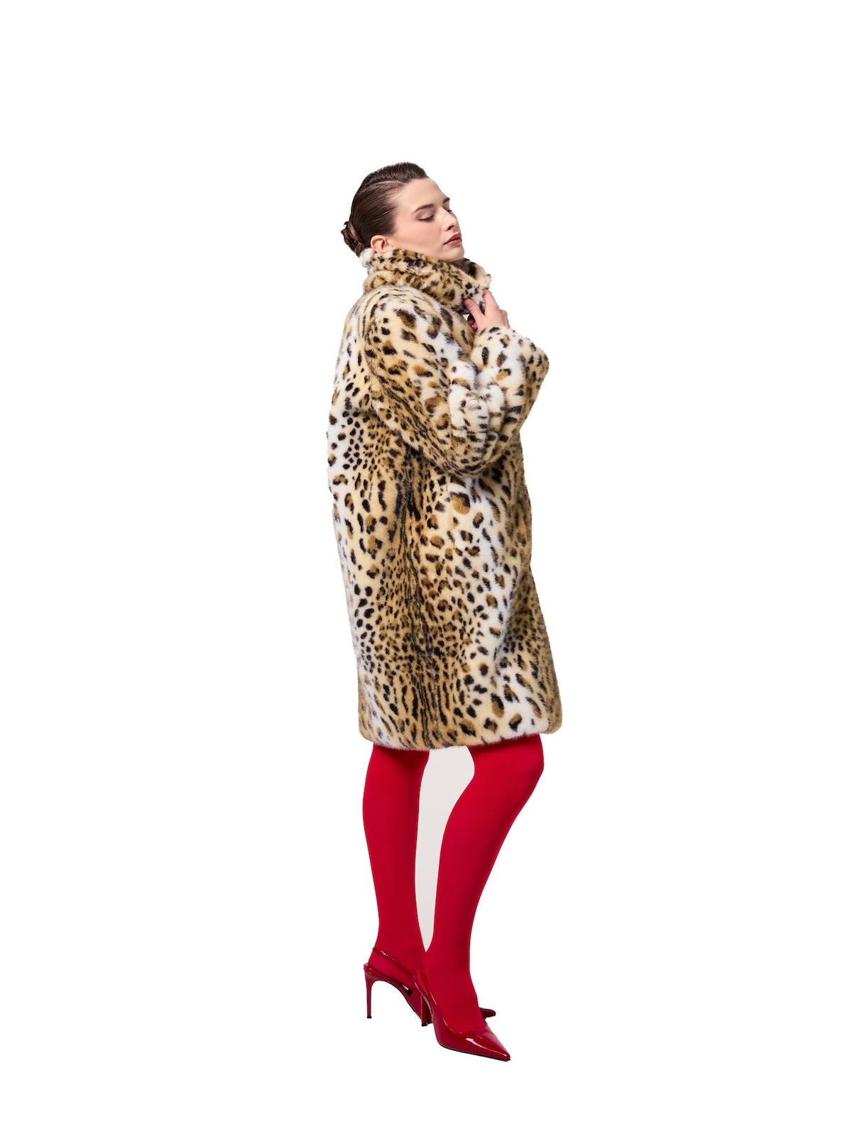 AUDREY coat in Leopard — side profile showcasing the plush faux fur texture, bold leopard print design, elevated stand collar, and elegant midi-length fit.
