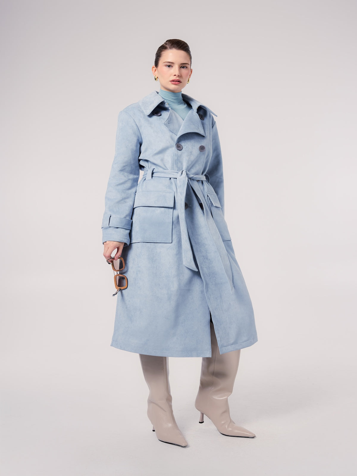 GRACE trench coat in Cloud — model wearing a belted faux suede trench coat with a double-breasted silhouette, styled with knee-high boots and a coordinating turtleneck for a refined contemporary look.