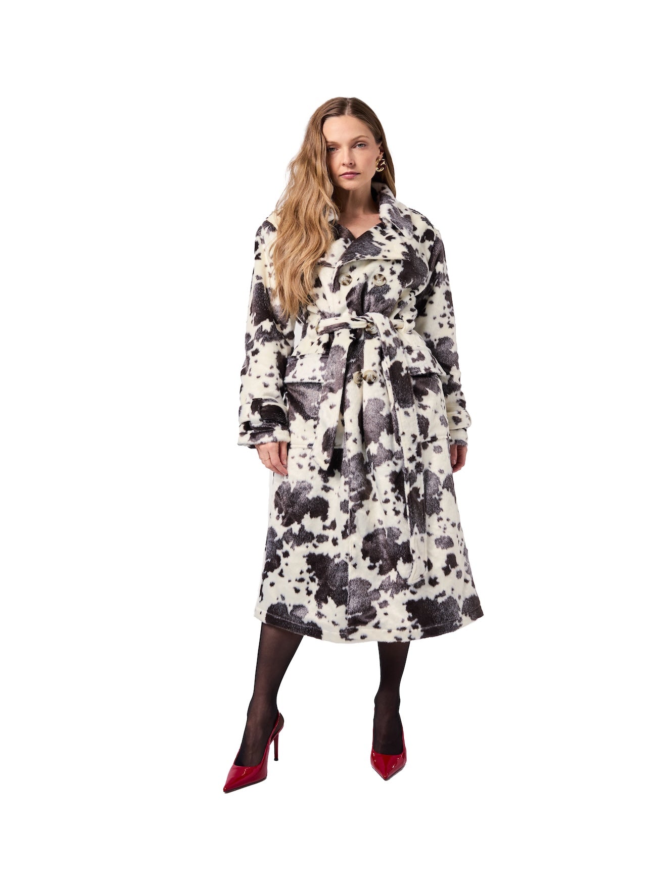 GRACE coat in Cow Noir — front view of a full-length black-and-ivory cow print faux fur coat featuring a double-breasted design, wide lapels, self-tie belt, and luxurious statement silhouette.