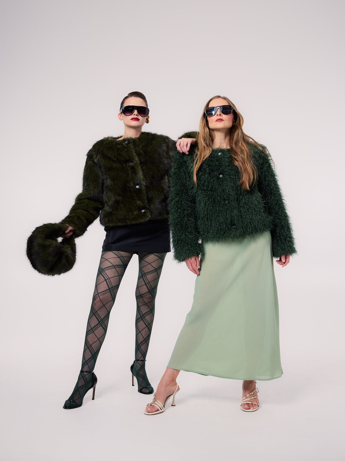 LOUISE jacket in Evergreen — models wearing vegan faux fur jackets in complementary Evergreen textures, creating a sophisticated editorial look with coordinated cold-weather styling.