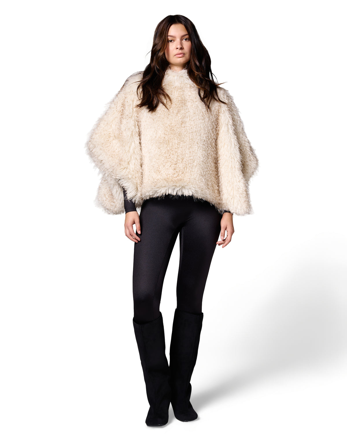 Model wearing the FREED Collette Pebble faux fur cape, featuring soft cream tones and a relaxed statement silhouette.