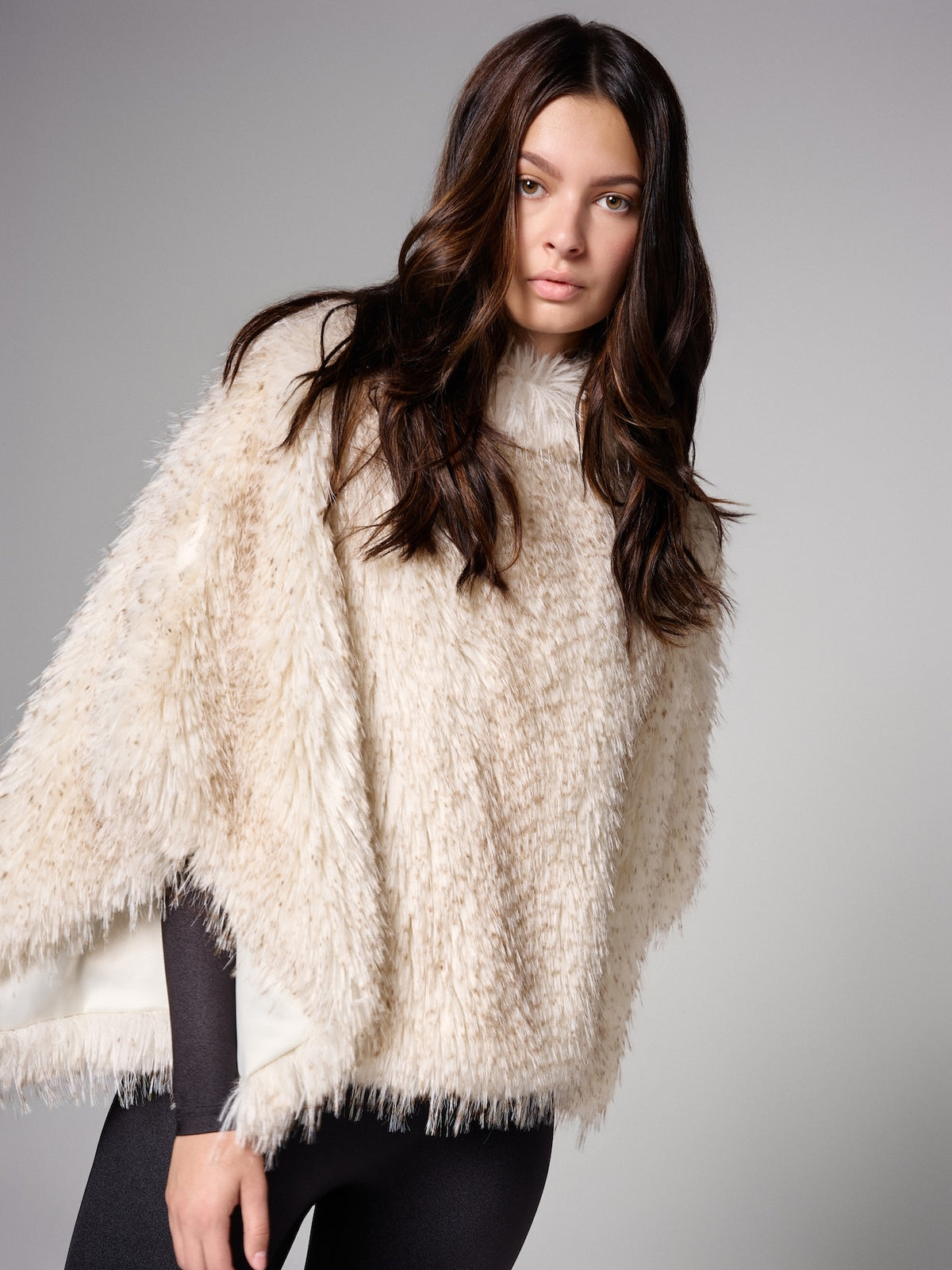 FREED Collette Pebble cape in plush ivory faux fur, bringing soft texture to a sleek monochrome look.