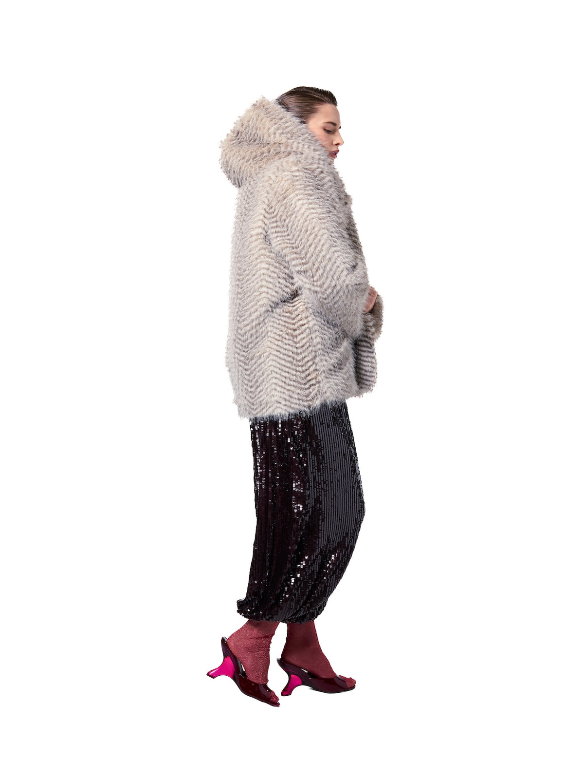 Side view of the NIKI Snow Lynx hooded faux fur jacket showcasing the soft textured fur, oversized hood, and relaxed fit.