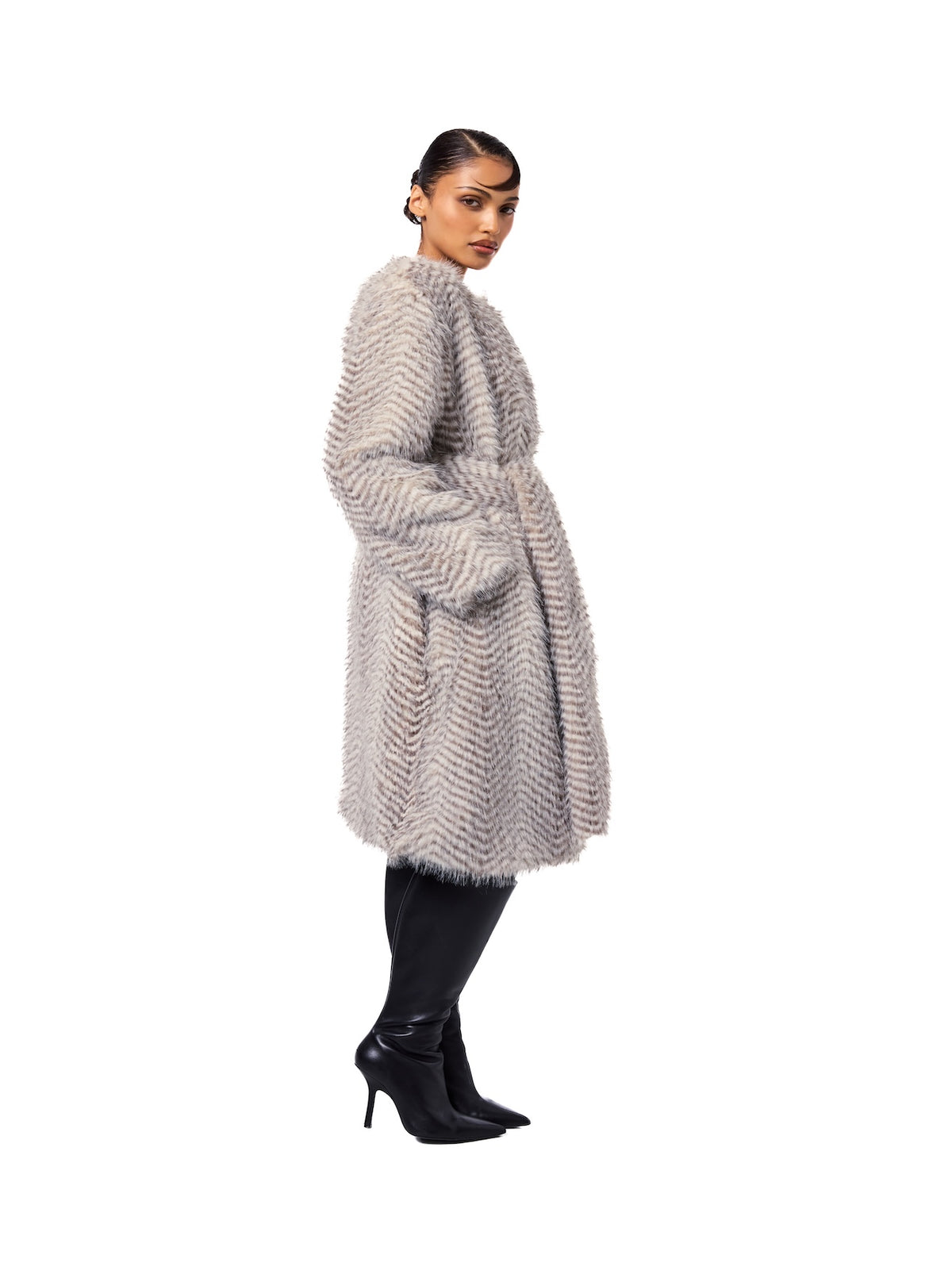 Side view of the STELLA Snow Lynx faux fur coat showcasing the luxurious textured fur, belted waist, and sophisticated midi-length design.